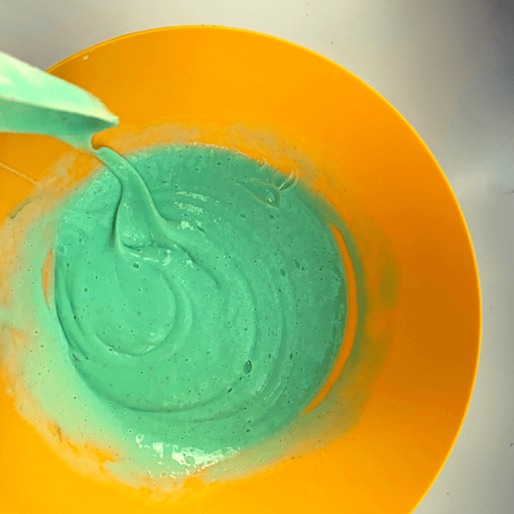 mixing slime with a mixing tool in a bowl